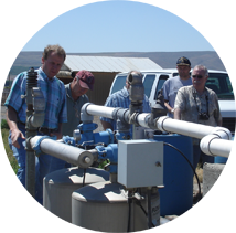 Troy Peters (left) giving a demonstration on drip filtration systems